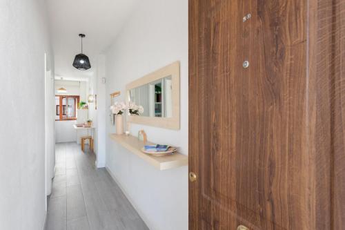 a hallway with a bathroom with a wooden door at Martimar Candelaria in Candelaria