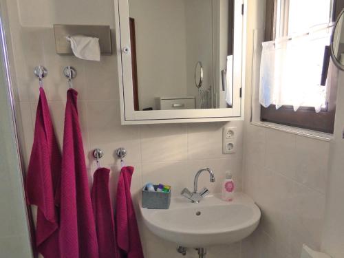 a bathroom with pink towels and a sink at Ferienhaus Höhenflug in Attendorn