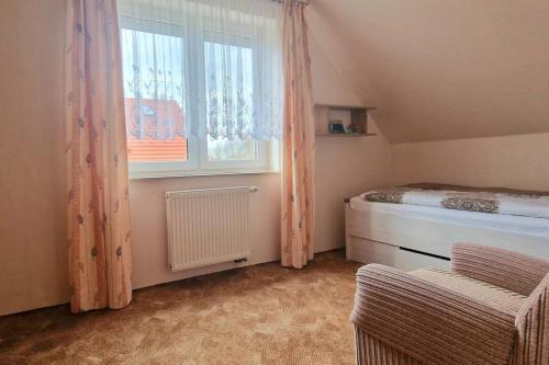 a bedroom with a bed and a large window at Apartment Kleine Auszeit in Wiendorf