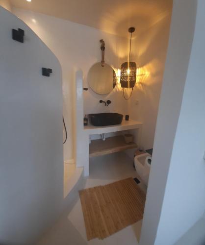 a bathroom with a sink and a toilet at Batsi view house in Andros