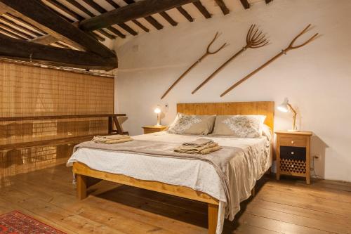 a bedroom with a bed with antlers on the wall at Masia del siglo xvi in Vallbona