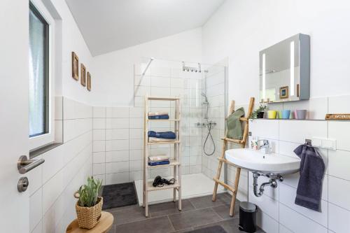 a bathroom with a sink and a shower at Ferienhaus 14 in Bad Arolsen