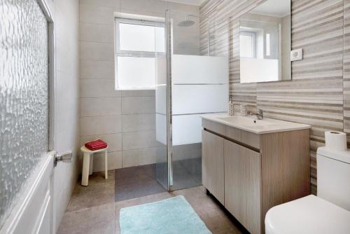 a bathroom with a sink and a shower at Casa Dona Isaura in Ponta Delgada