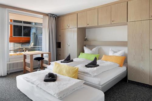 a bedroom with two beds with towels on them at Fewo Berggipfel am Feldberg in Feldberg