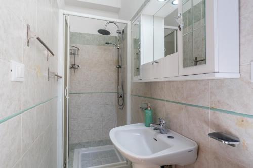a bathroom with a sink and a shower at Leondoro - Pirandello in Santa Flavia