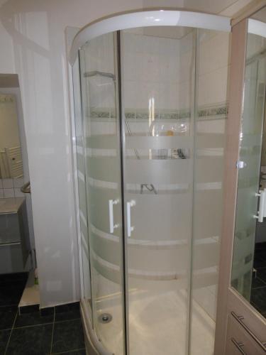 a shower with a glass door in a bathroom at Maison de Village in Puimoisson