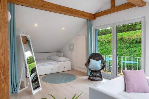 a room with a couch and a bed and a window at Ferienhaus Engelsberghof in Endingen