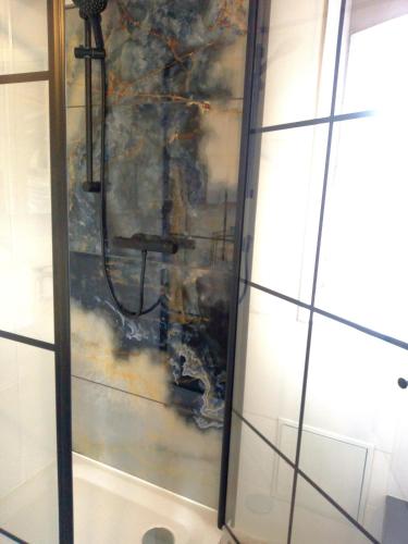 a glass wall with a painting on the wall at Hof Sorgenfrei in Buch