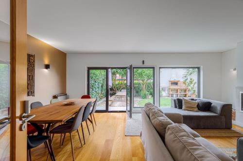 a living room with a table and a couch at Casa das Fontes - House of Wells in Parede