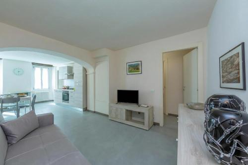 a living room with a couch and a television at Nonna Sandrina in Monferrato hills - Happy Rentals in Garbagna