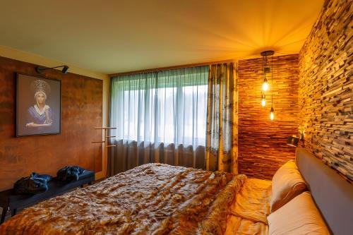 a bedroom with a bed and a large window at Chalet-Sonnengarten in Hinterzarten
