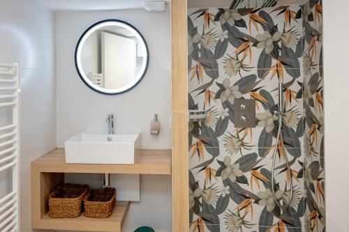 a bathroom with a sink and a mirror at La suite des Sommets in Barberaz