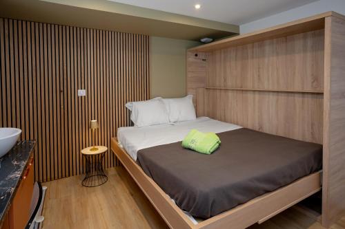 a small bedroom with a bed and a sink at La suite des Sommets in Barberaz