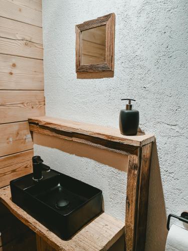a bathroom with a black sink and a mirror at Ferienwohnung Katie in Hopfgarten im Brixental