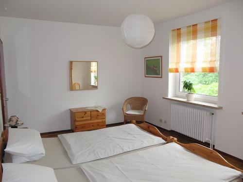 a bedroom with two beds and a window at Ferienwohnung Lortz in Cuxhaven