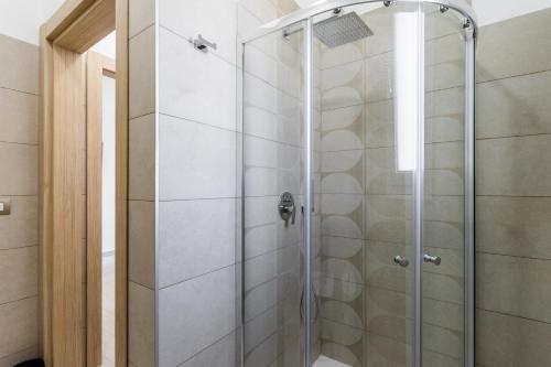 a shower with a glass door in a bathroom at Le scuderie 5 in Galatone
