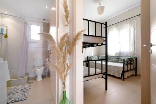 a room with two bunk beds and a bathroom at Villa Ermina Paleros in Paleros