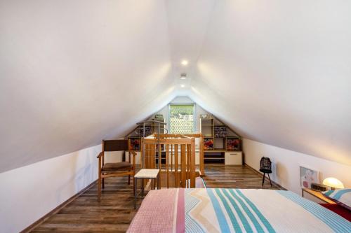 a attic bedroom with a bed and a window at Ferienwohung Marion - Hohnstein in Rathewalde