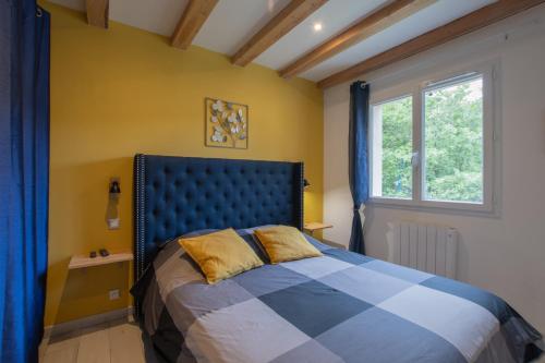 a bedroom with a bed and a window at Villa La Fenière in Payzac
