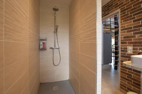 a bathroom with a shower and a sink at Villa La Fenière in Payzac