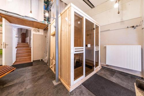 a room with wooden walls and stairs in a building at Ferienhaus1856de mit Sauna in Görlitz