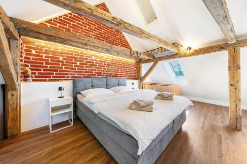 a bedroom with a bed and a brick wall at Ferienhaus1856de mit Sauna in Görlitz