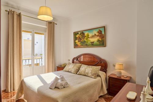 a bedroom with a bed with two towels on it at Casa Ángeles in Cuevas Bajas