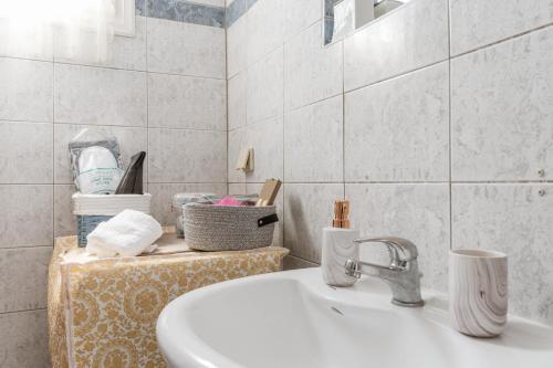 a bathroom with a sink and a counter with towels at Penny 's House in Artemonas