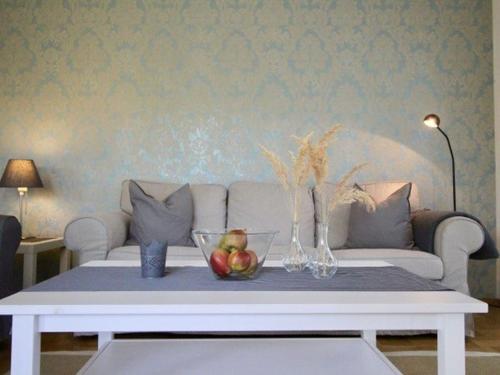 a living room with a couch and a table with fruit on it at Komfort-Ferienwohnung am See in Bodman-Ludwigshafen