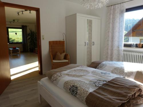 a bedroom with a bed and a large window at Haus Wiesengrund in Forbach