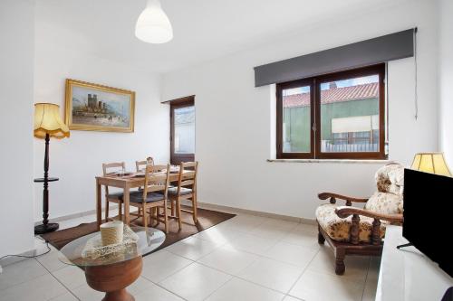 a living room with a table and chairs at A O - Augusta in Peniche