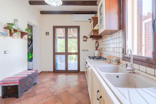 a large kitchen with a sink and a window at La Casa del Vento Plemmirio in Plemmirio
