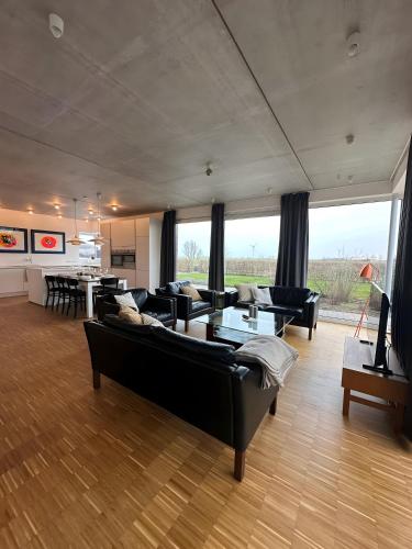 a large living room with couches and a table at Großzügiges modernes Ferienhaus in Neuharlingersiel