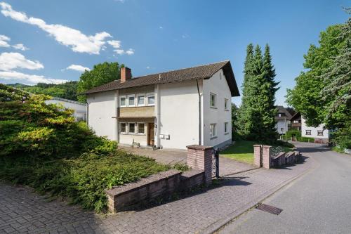 a white house on the side of a road at Ferien Am Weinberg in Kappelrodeck