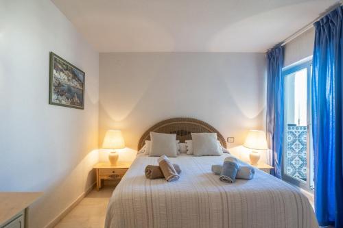 a bedroom with a bed with two pillows on it at Apartment with Swimming-pool in Marbella