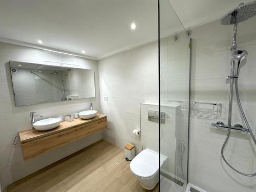 a bathroom with two sinks and a glass shower at Apartment with Swimming-pool in Marbella