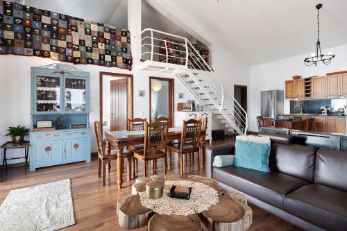 a living room with a couch and a table at Breathe Nature - Beach House Azores in Feteira