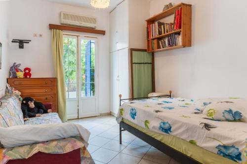 a child sitting on a bed in a bedroom at Charmante ferienwohnung in Tinos