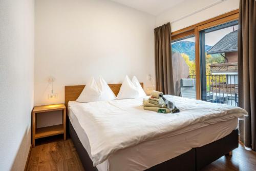 a bedroom with a bed with a teddy bear on it at App Kronplatz Villa Colli in Valdaora