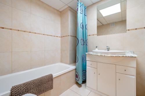 a bathroom with a bath tub and a sink at Sara in L'Aldea