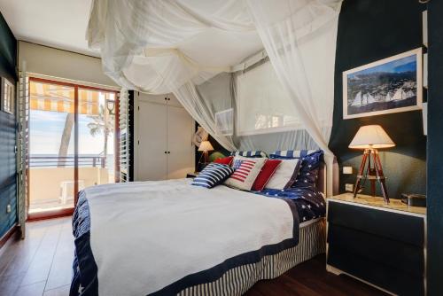 a bedroom with a bed with pillows and a window at Apartment - Car included in Estepona