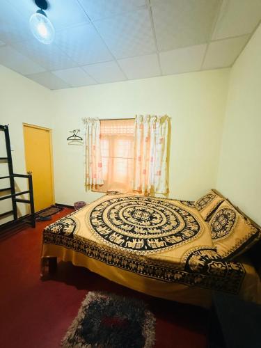 a bedroom with a bed in a room with a window at C&C Holiday Home in Nikawatawana