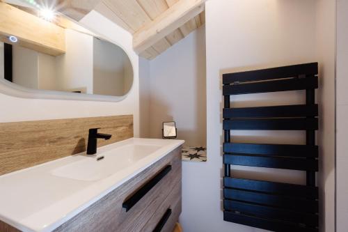 a bathroom with a sink and a mirror at Meribel le chalet d'eugénie in Les Allues