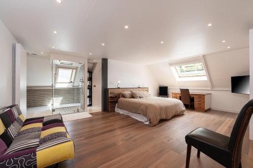 a bedroom with a bed and a couch in it at Chambre d'hôtes - Ty Castel in Ploeren