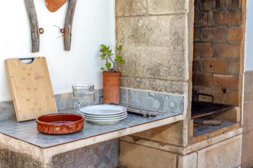 a counter with plates and bowls on it at Villa Kassiopea in Cala Blanca