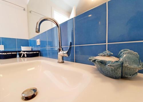 a bathroom with a sink and a faucet at La Perla del Golfo in Capoliveri