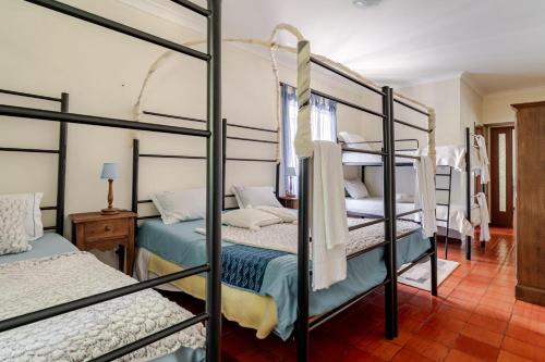 a bedroom with four bunk beds in a room at Casa da Quinta da Castanheira in Cepões