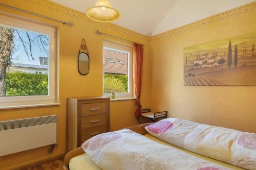 a bedroom with a bed and a window at Ferienhaus Gerster in Mitten