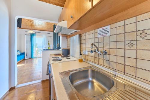 a kitchen with a sink and a counter top at Dolphin villa 2 in Gaios