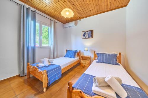 a bedroom with two beds and a window at Dolphin villa 2 in Gaios